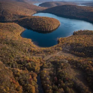 Aerial view of Doubling Gap Lake surrounded by autumn foliage - Parksguidance Official